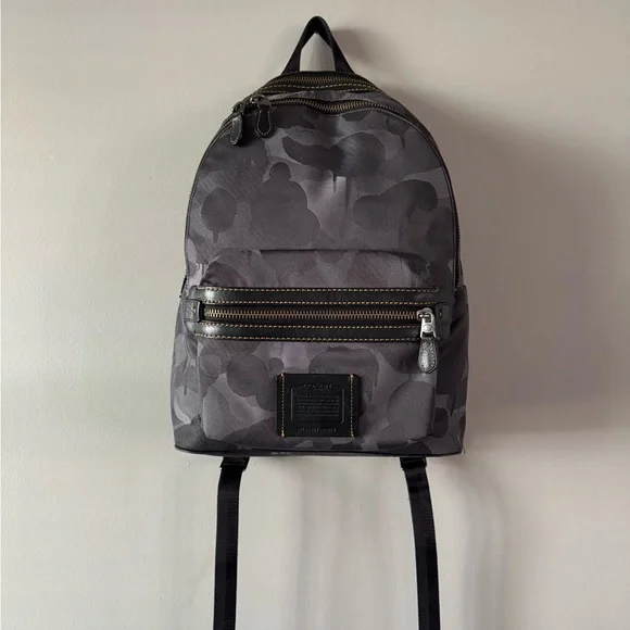coach backpack camouflage Gotham Pack Sling CAF37 Camo Green Signature Leather Crossbody Luxe Fashion Finds Signature coated canvas and smooth calf leather Two separate main compartments with zip closures Inside zip cell phone and multifunction pockets Fabric lining Top handle with 3 1/4 drop Outside zip pocket Adjustable shoulder straps 12 1/2 (L) x 16 3/4 (H) x 6 (W) Style No. Coach Outlet West Backpack In